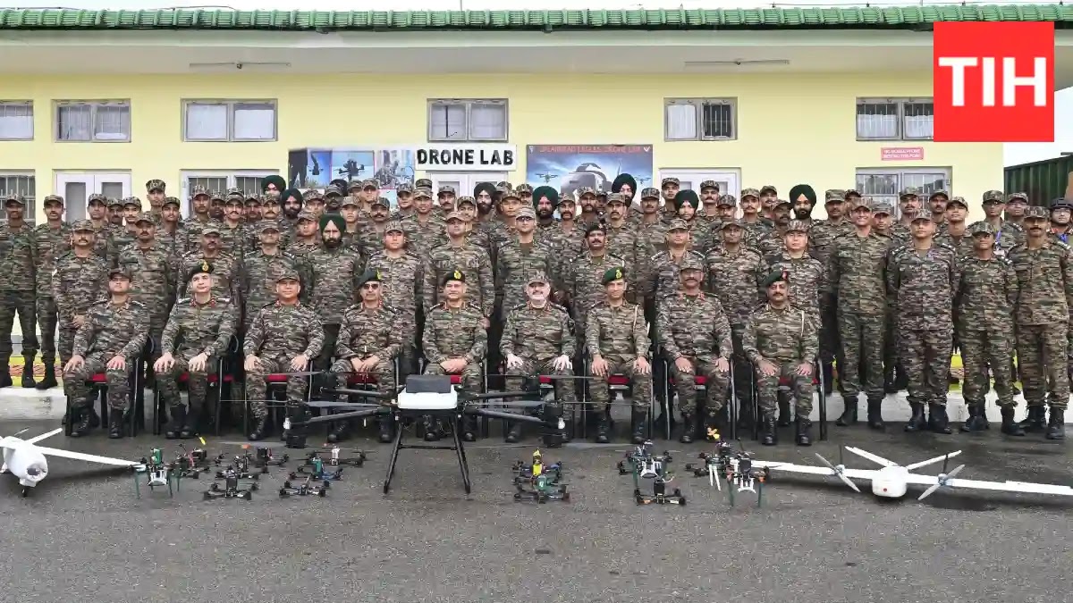 A group photo of COAS General Upendra Dwivedi and several army officers. General Dwivedi is positioned in the center. The group is standing in what appears to be a military facility, possibly the 'Drone Lab', with machinery or equipment visible in the background.